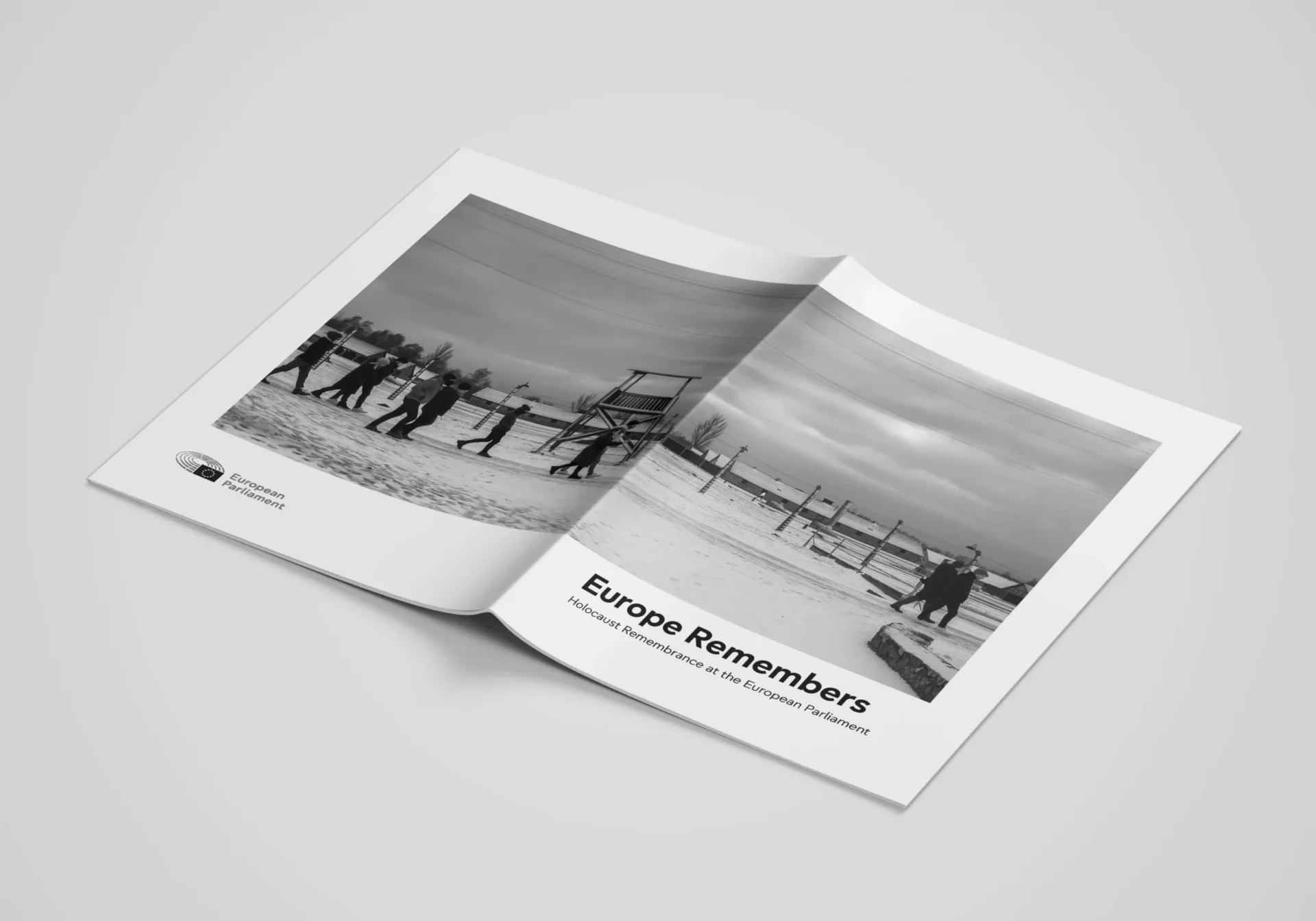 A spread booklet showing the front and back page, with the title ‘Europe Remembers: Holocaust Remembrance at the European Parliament’, a cover photo displaying Auschwitz-Birkenau, and the logo of the European Parliament.