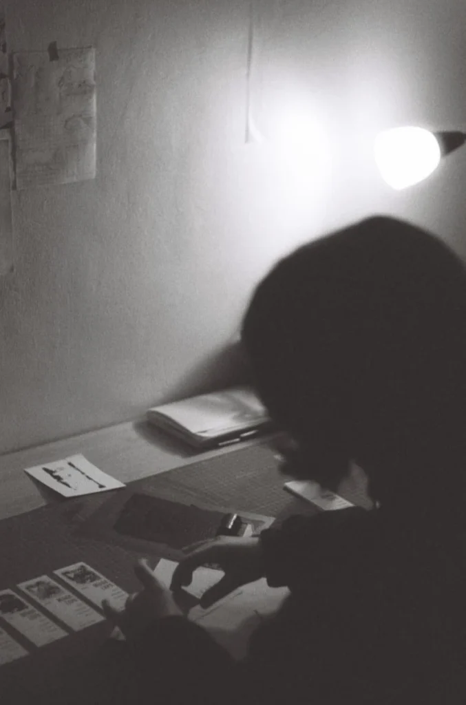 Maria, the graphic designer and author of the website, printing linocut stamps onto exhibition tickets in her studio.