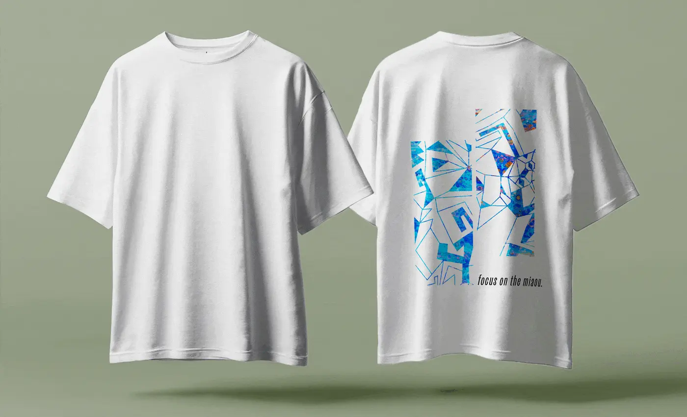 A back of a t-shirt with graphics from the 'Miaou Expo' poster illustration and a caption 'focus on the miaou'.